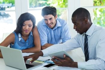 Three people looking at a computer